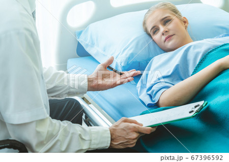 Doctor in professional uniform examining patient at hospital 67396592