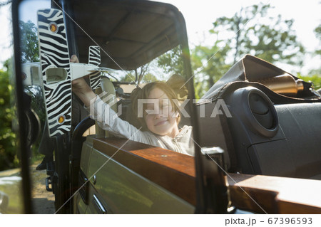 portrait of smiling Six year old boy in safari vehicle, Botswana 67396593