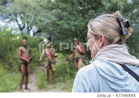 Tourists on a walking trail with members of the San people, bushmen. 67396888