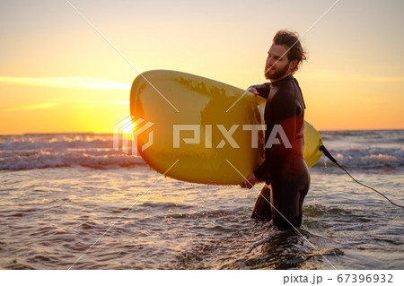 Male surfer with surfboard in sea Male surfer with surfboard in sea 67396932