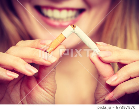 Smilling girl is breaking cigarette Smilling girl is breaking cigarette 67397970