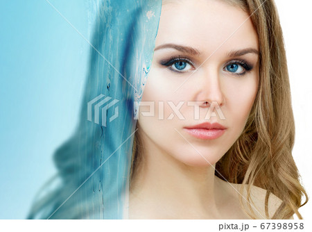 Sensual woman under water splash over white background. 67398958