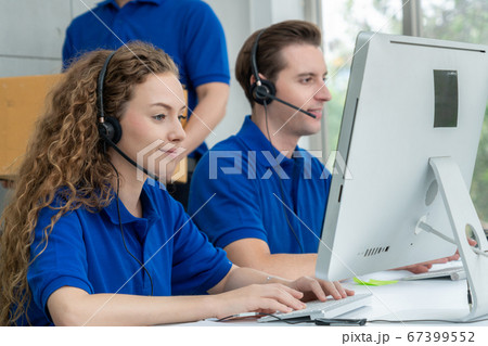 Business people wearing headset working in office Business people wearing headset working in office 67399552