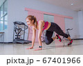 Asian woman exercising in the gym, She was pretending to "plank" 67401966