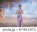 Woman wearing typical thai dress with thai style, Beauty fantasy Thai dress traditional costume on brick in old temple 67401971