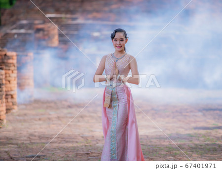 Woman wearing typical thai dress with thai style, Beauty fantasy Thai dress traditional costume on brick in old temple Woman wearing typical thai dress with thai style, Beauty fantasy Thai dress traditional costume on brick in old temple 67401971