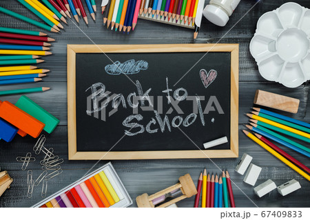 School supplies on black board background. School supplies on black board background. 67409833