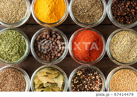 Colourful seasonings in bowls on wooden background. Collection of spices 67414479