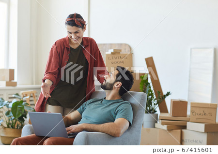 Couple using laptop at home Couple using laptop at home 67415601