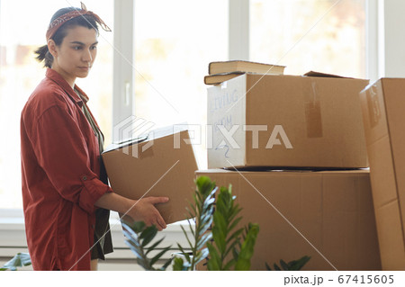 Woman carrying things in box Woman carrying things in box 67415605
