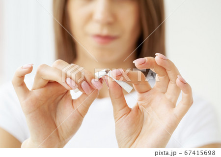 Stop smoking, close up of woman breaking cigarette 67415698