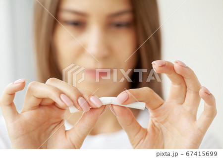 Stop smoking, close up of woman breaking cigarette Stop smoking, close up of woman breaking cigarette 67415699