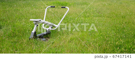 outdoor exercise machine stands on grassy ground 67417141