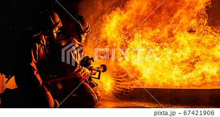 Firefighters use twirl water fog spraying down 67421906