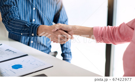 Two confident business man shaking hands during a 67422977