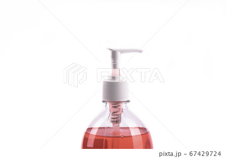 Red liquid soap in plastic pump bottle isolated on white background. 67429724