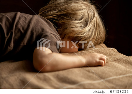 child is lying on the bed face down 67433232
