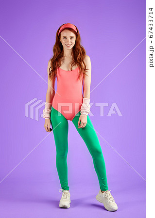 Motivated young red-headed woman with fit body wears 80s sportclothes 67433714