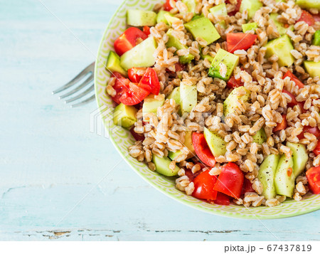 Fresh farro spelt salad with tomatoes, avocado Fresh farro spelt salad with tomatoes, avocado 67437819