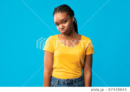 Offended African American Girl Sulking Looking At Camera, Blue Background 67439643