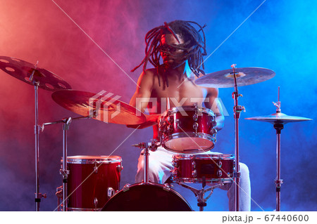 handsome attractive man showily playing on drums 67440600