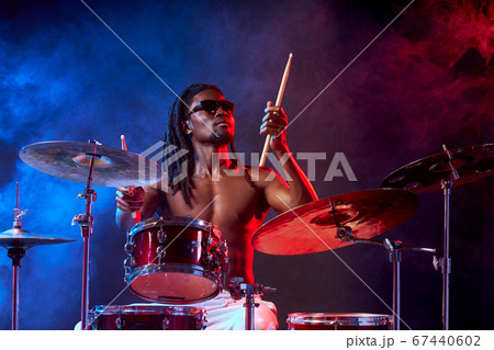 handsome attractive man showily playing on drums 67440602