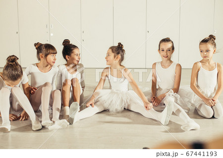 group of funny and happy children ballerinas sitting on floor 67441193