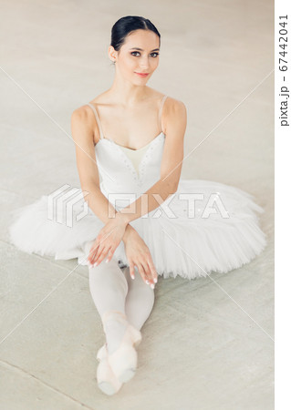 beautiful dancer having a rest on the floor and looking at the camera beautiful dancer having a rest on the floor and looking at the camera 67442041