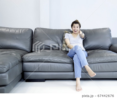 Woman at home watching tv Woman at home watching tv 67442676
