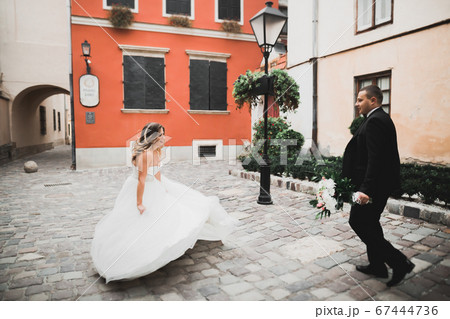 Perfect couple bride, groom posing and kissing in their wedding day Perfect couple bride, groom posing and kissing in their wedding day 67444736