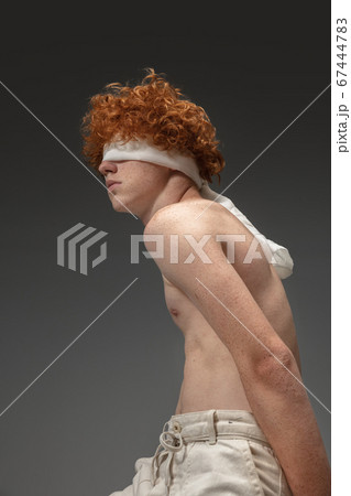 Portrait of beautiful redhead man isolated on grey studio background. Concept of beauty, skin care, fashion and style Portrait of beautiful redhead man isolated on grey studio background. Concept of beauty, skin care, fashion and style 67444783