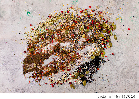 Mixed together a variety of seeds located on a white background Mixed together a variety of seeds located on a white background 67447014
