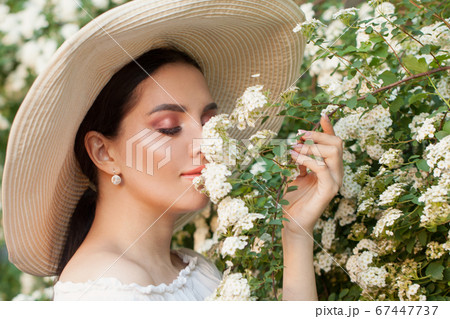 Lovely girl with flowers outdoor portrait 67447737