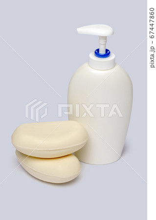 piece of soap and bottle of liquid soap over light grey backgound with clipping path 67447860