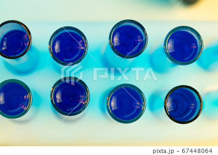 Laboratory test tubes with blue liquid close up 67448064