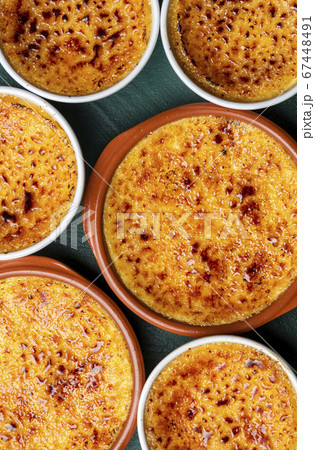 Creme brulee top view close-up. Bowls with burned Creme brulee top view close-up. Bowls with burned 67448491