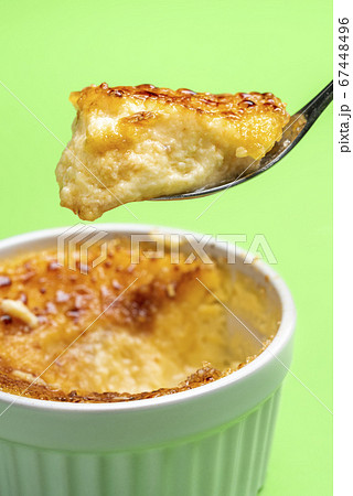 Creme brulee in a spoon close-up. Eating creme 67448496