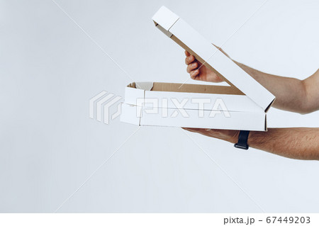 Courier hands giving packed food delivery close up 67449203