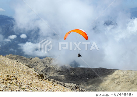 paraglider taking off from the mountain 67449497