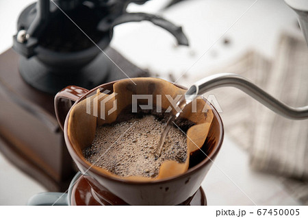 dripping coffee image with mug , paper filter and 67450005