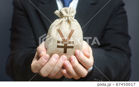 A man holds out a yen yuan money bag. Trade, economics. Granting financing business project or education. Provision cash financial loan credit. Bank deposit. Budget management, tax collection. 67450017