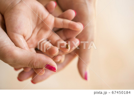 Mothers hand cupping her childs hand on which Mothers hand cupping her childs hand on which 67450184
