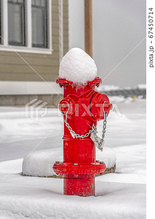 Red fire hydrant on ground with a blanket of snow Red fire hydrant on ground with a blanket of snow 67450714