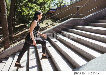 Street fitness.Young woman running on the stairs  67451796