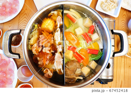 Double flavor hot pot on wood background Double flavor hot pot on wood background 67452418