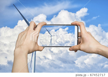 Girl taking pictures on mobile smart phone in Wind Girl taking pictures on mobile smart phone in Wind 67452717
