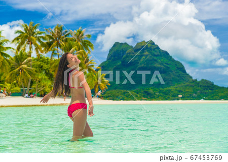 Bora bora luxury vacation travel paradise bikini woman swimming at island in Tahiti, French Polynesia. Popular honeymoon destination holiday in South Pacific, Oceania 67453769