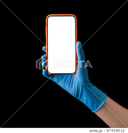 Doctor's hand in medical gloves holding phone isolated on black 67458512