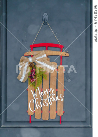 A holiday entryway with christmas door decoration 67458596