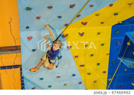 6 years old child climbing on a wall in a climbing center 6 years old child climbing on a wall in a climbing center 67460402
